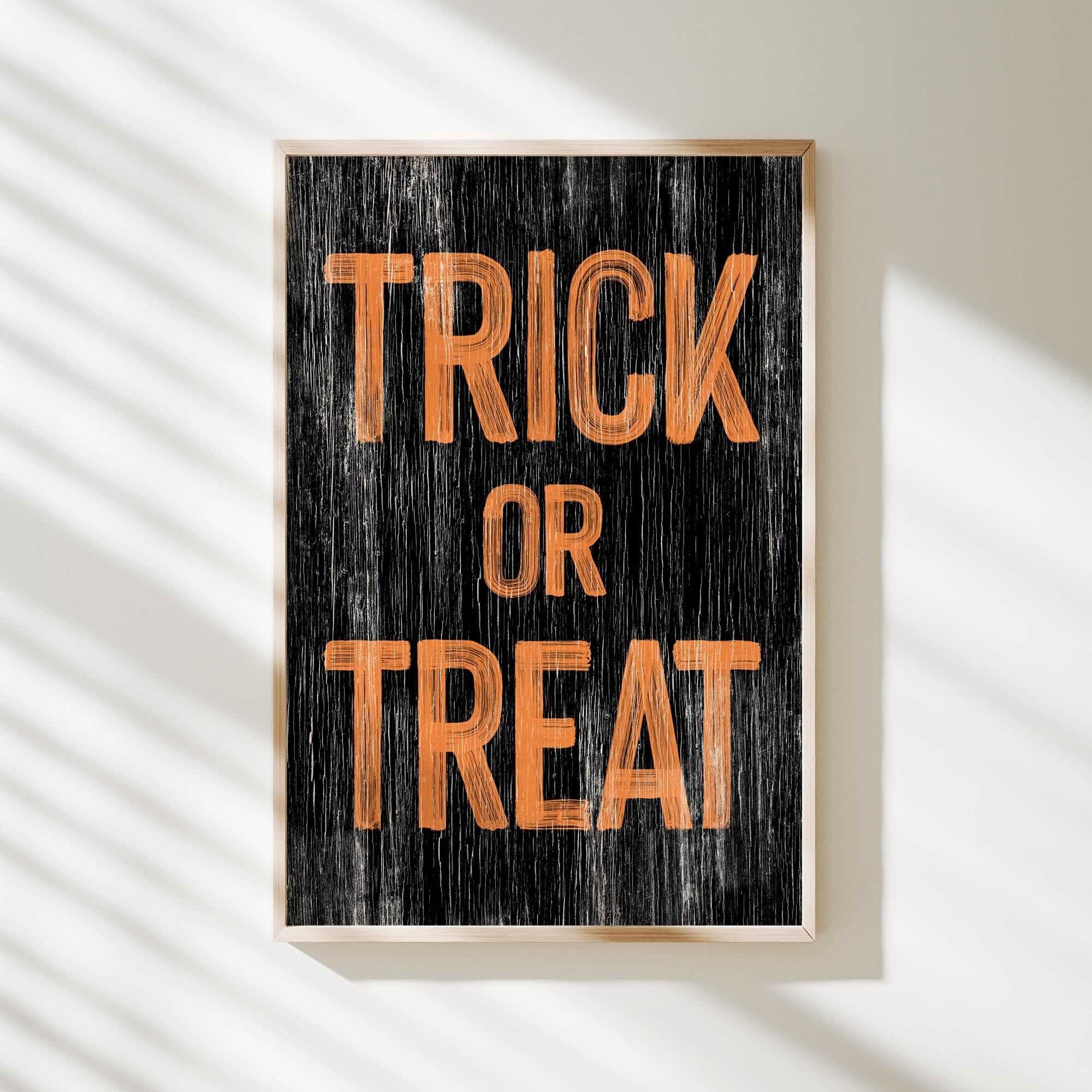 a trick or treat sign hanging on a wall