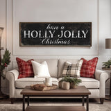 a living room with a christmas sign on the wall