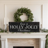 a fireplace with a wreath and a sign that says have a holly jolly christmas