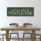 a table with chairs and a sign that says meet me under the mistletoe