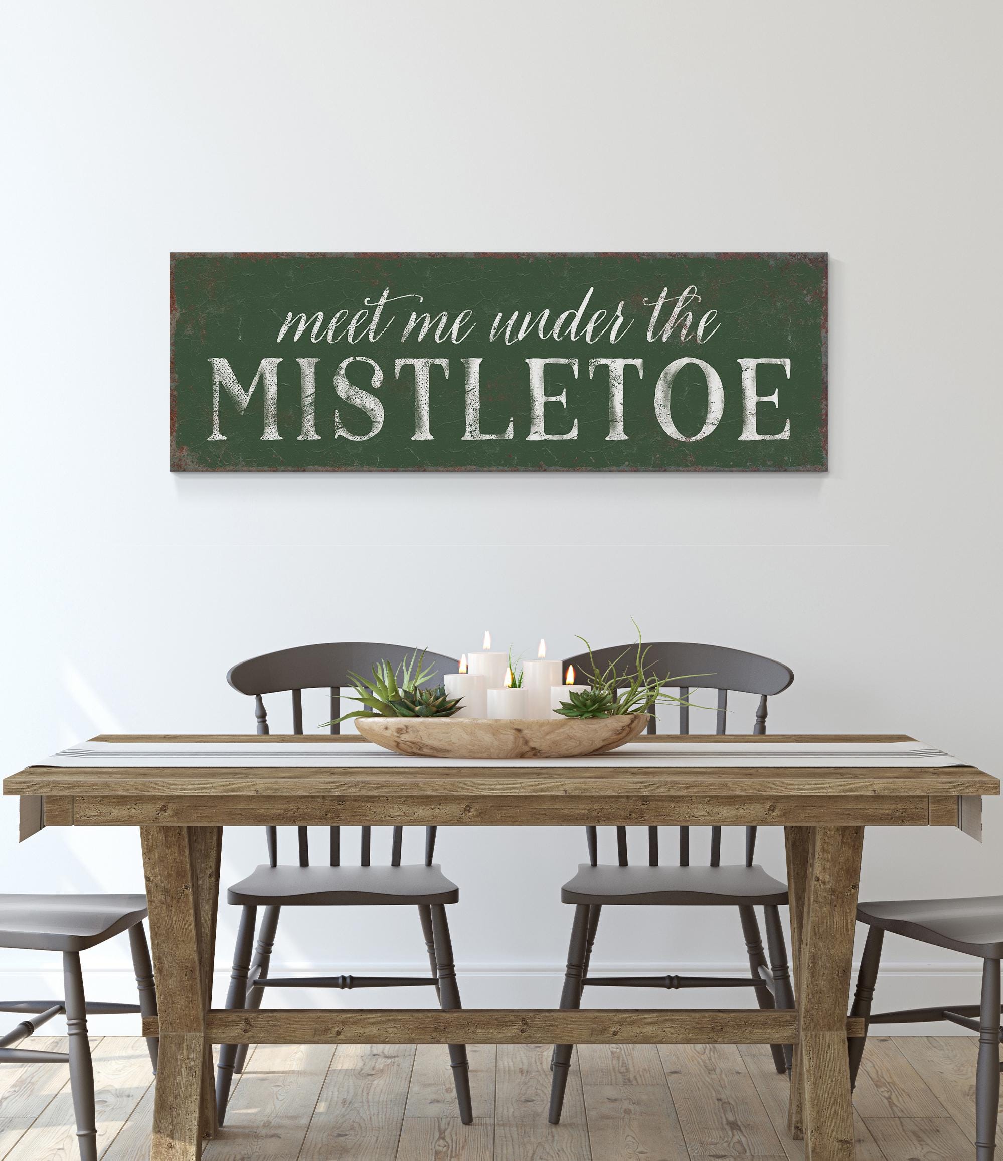 a table with chairs and a sign that says meet me under the mistletoe