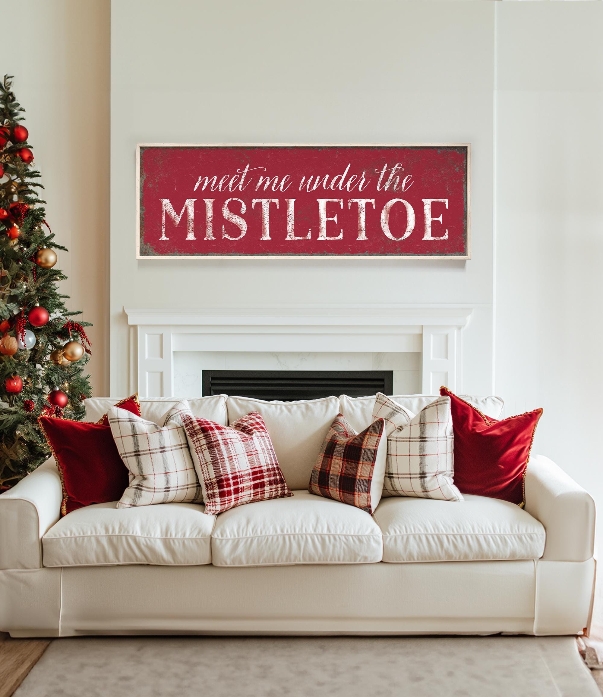 a living room with a white couch and a christmas tree