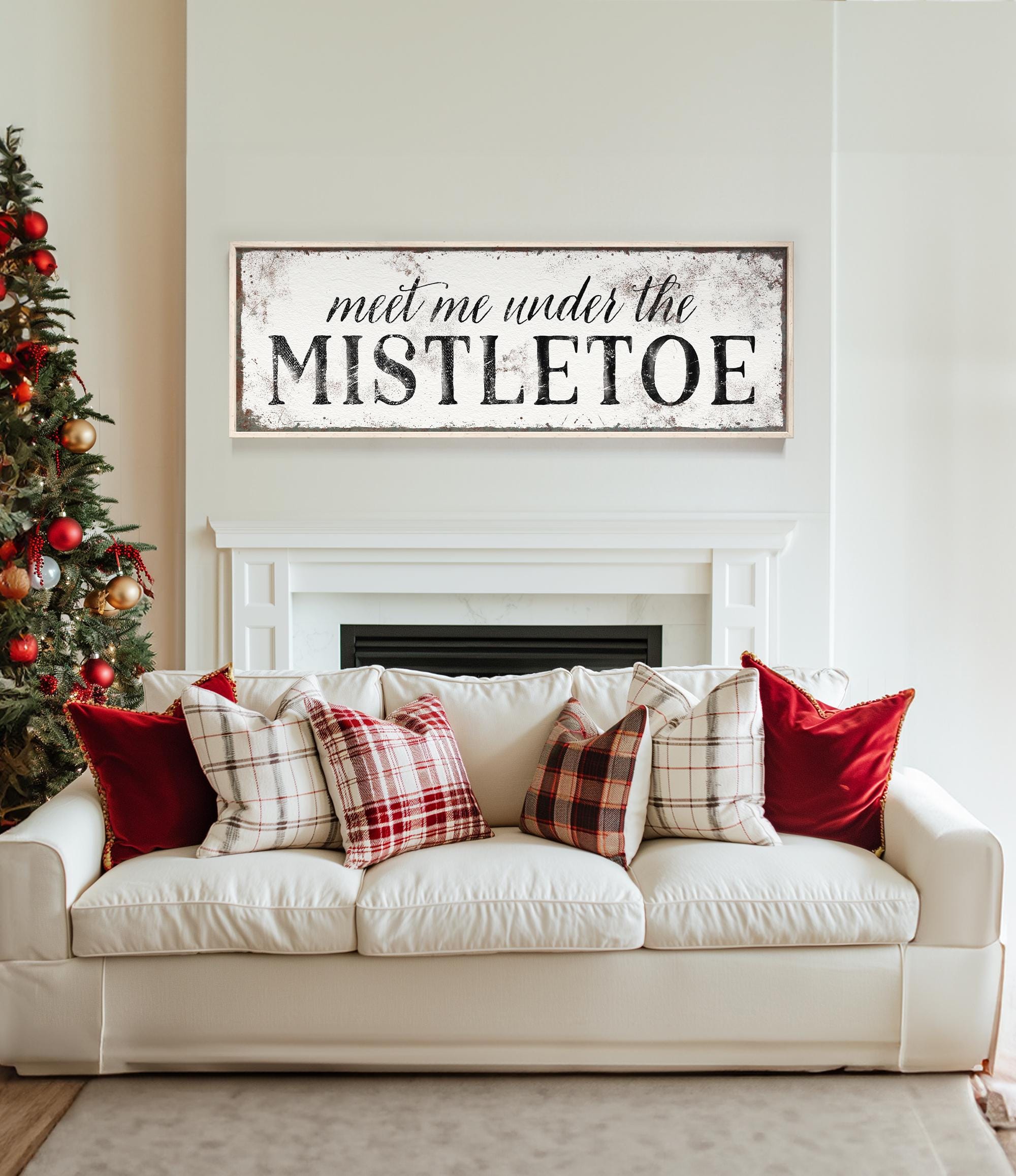 a living room with a white couch and a christmas tree