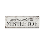 a sign that says meet me under the mistletoe