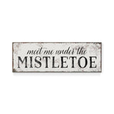 a sign that says meet me under the mistletoe