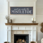 a fireplace with a sign above it that says, meet me under the mistlet