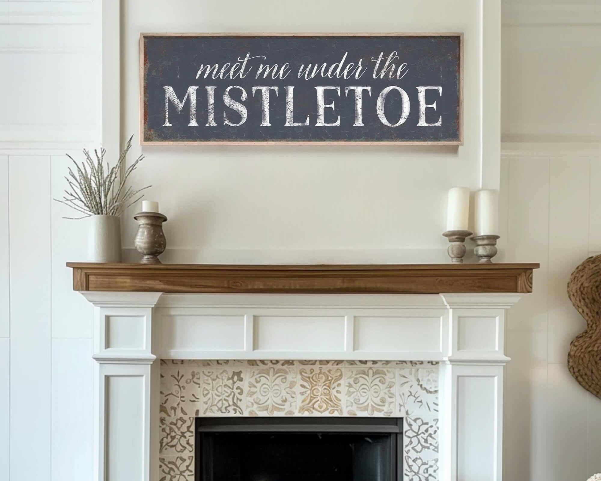 a fireplace with a sign above it that says, meet me under the mistlet