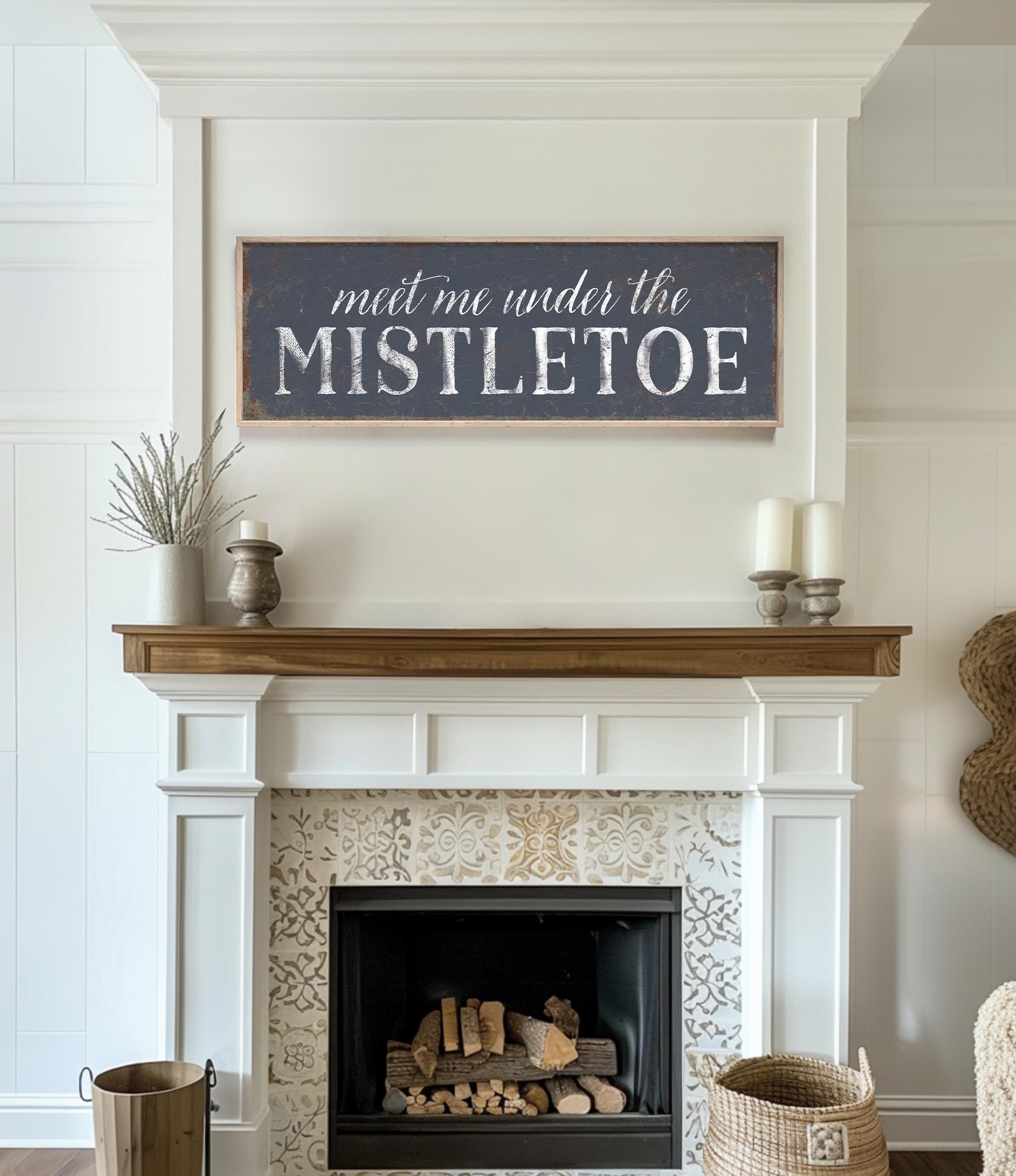 a fireplace with a sign above it that says, meet me under the mistlet