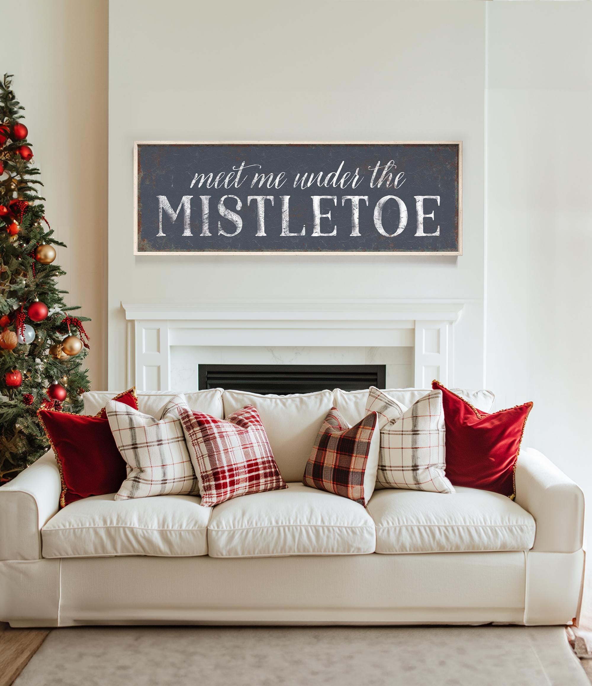 a white couch sitting in a living room next to a christmas tree