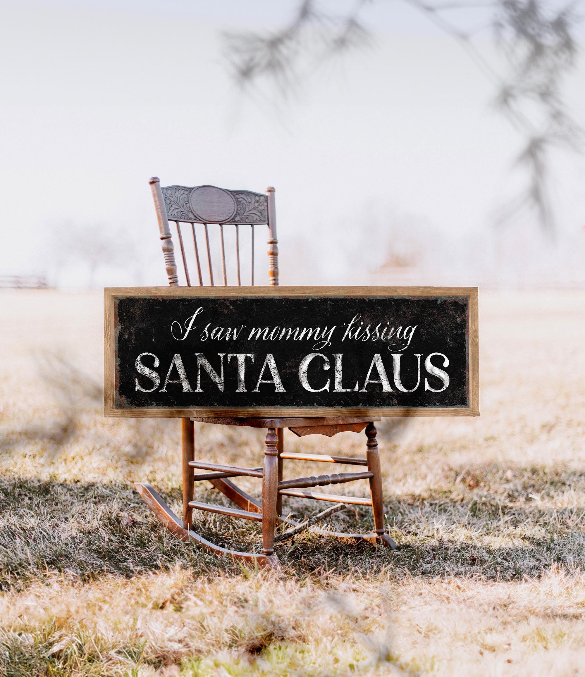 a wooden rocking chair with a sign that says i love mommy kissing santa claus