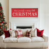 a living room with a white couch and a christmas tree