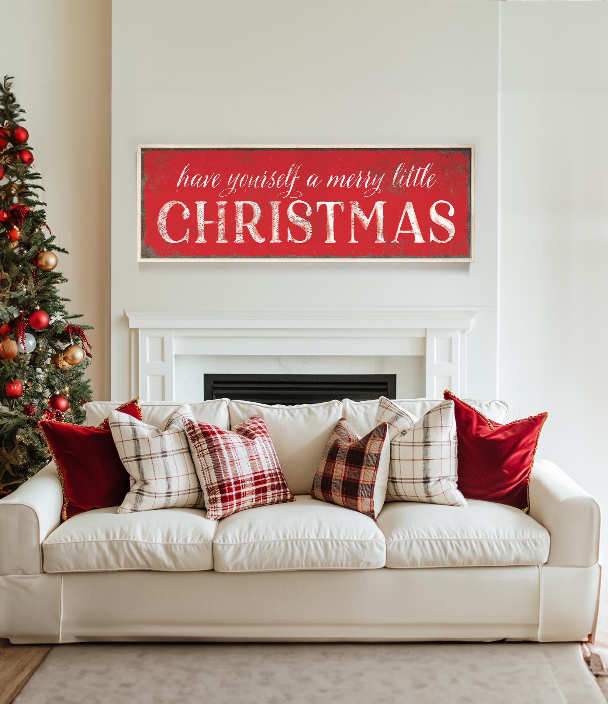 a living room with a white couch and a christmas tree