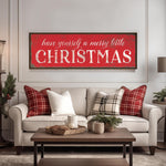 a living room with a christmas sign on the wall