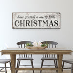 a table with chairs and a sign that says have yourself a merry little christmas