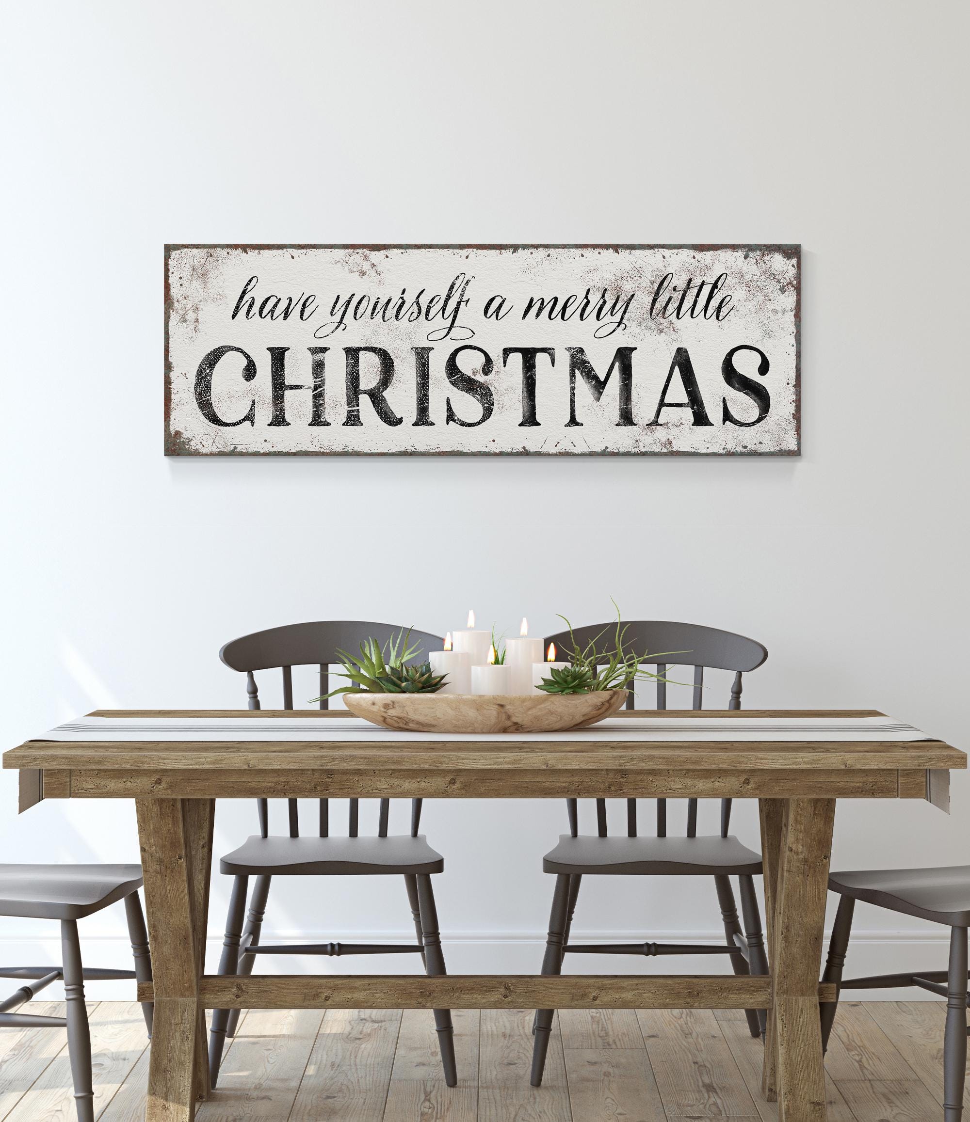 a table with chairs and a sign that says have yourself a merry little christmas