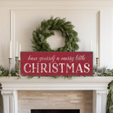 a fireplace with a christmas sign on top of it