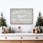 a christmas scene with a bed and breakfast sign