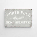 a metal sign that says north pole bed and breakfast