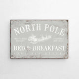 a metal sign that says north pole bed and breakfast