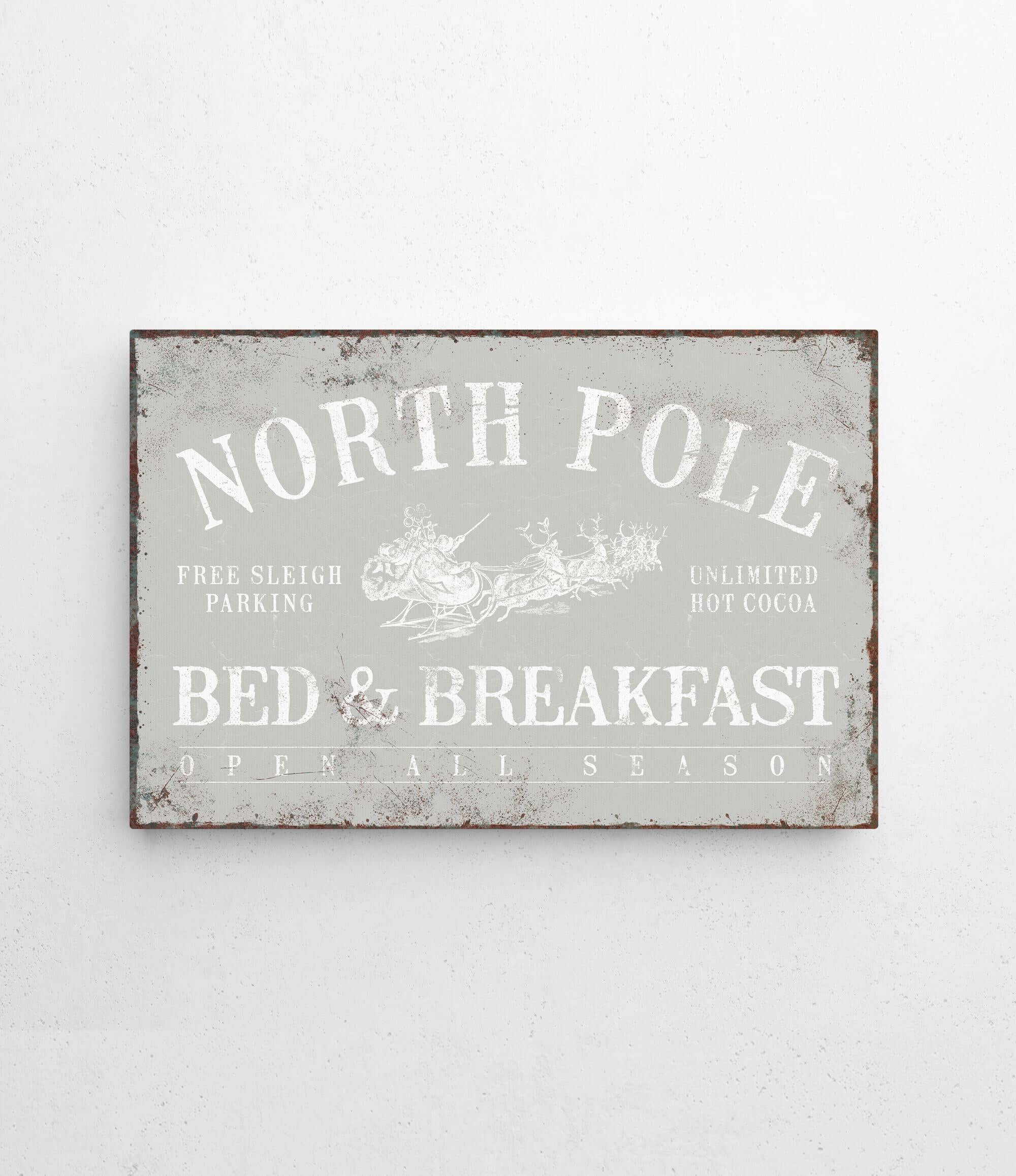 a metal sign that says north pole bed and breakfast