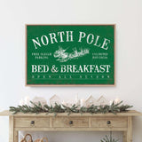 a christmas scene with a bed and breakfast sign