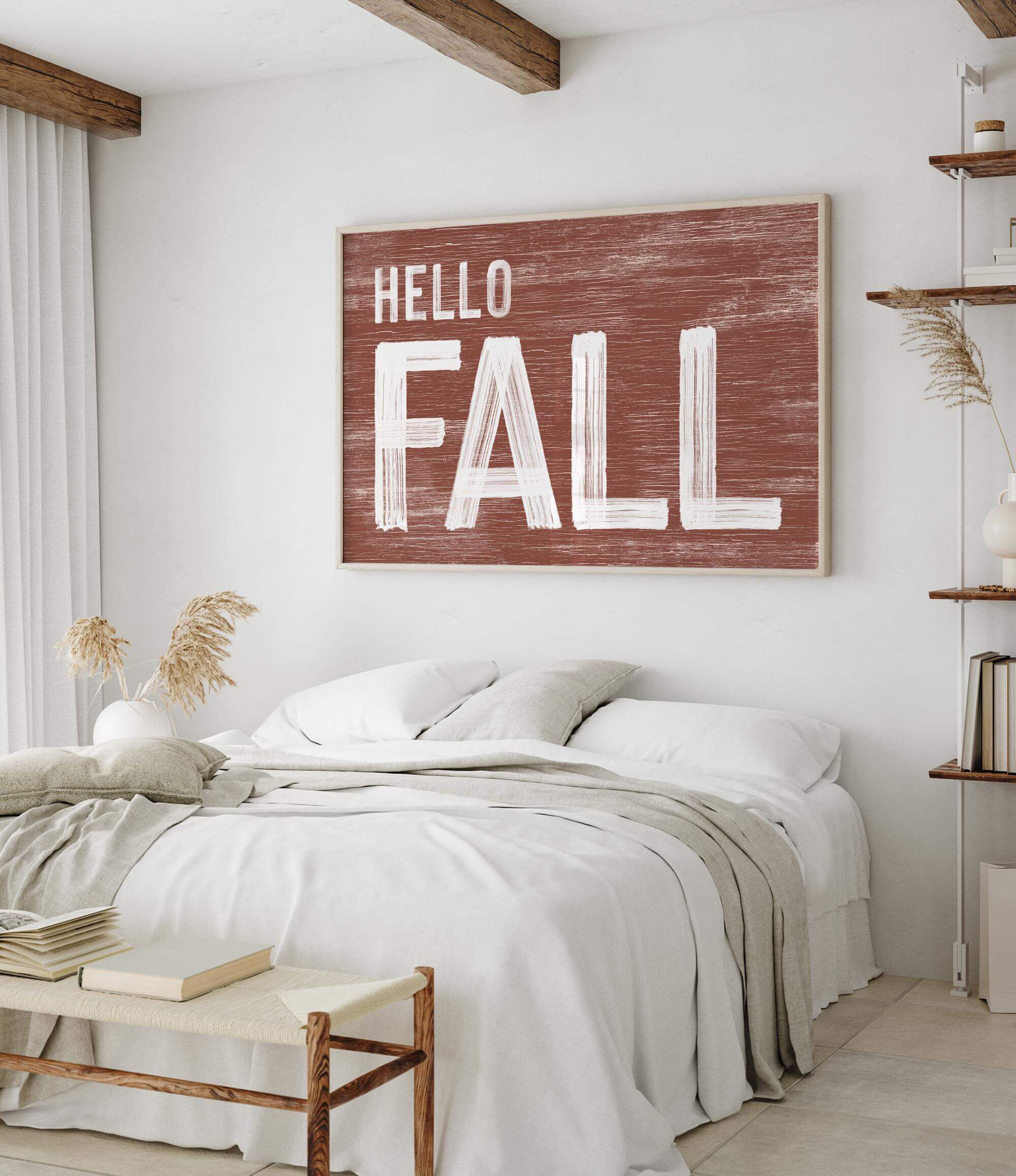 a bedroom with a white bed and a hello fall sign on the wall