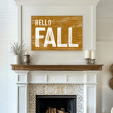 a picture of a fireplace with a hello fall sign above it