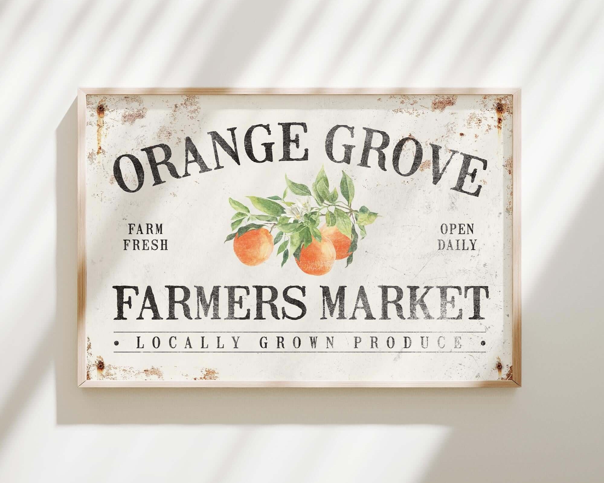 an orange grove farmers market sign hanging on a wall