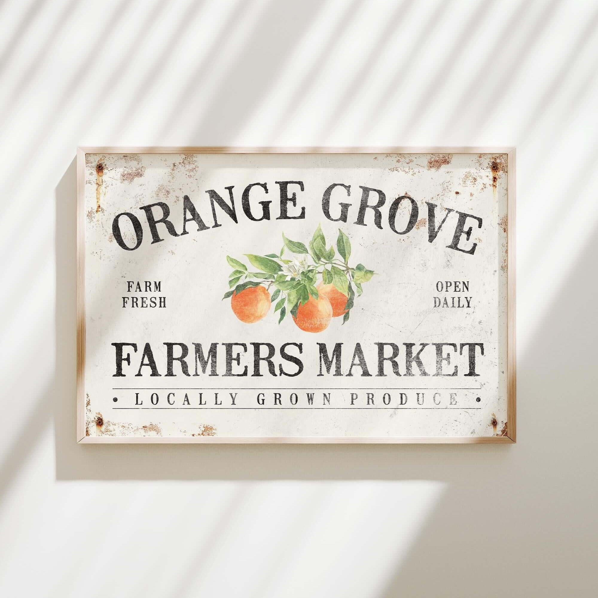 an orange grove farmers market sign hanging on a wall
