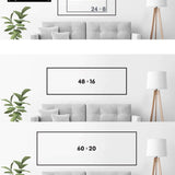 a white couch sitting next to a lamp on top of a table