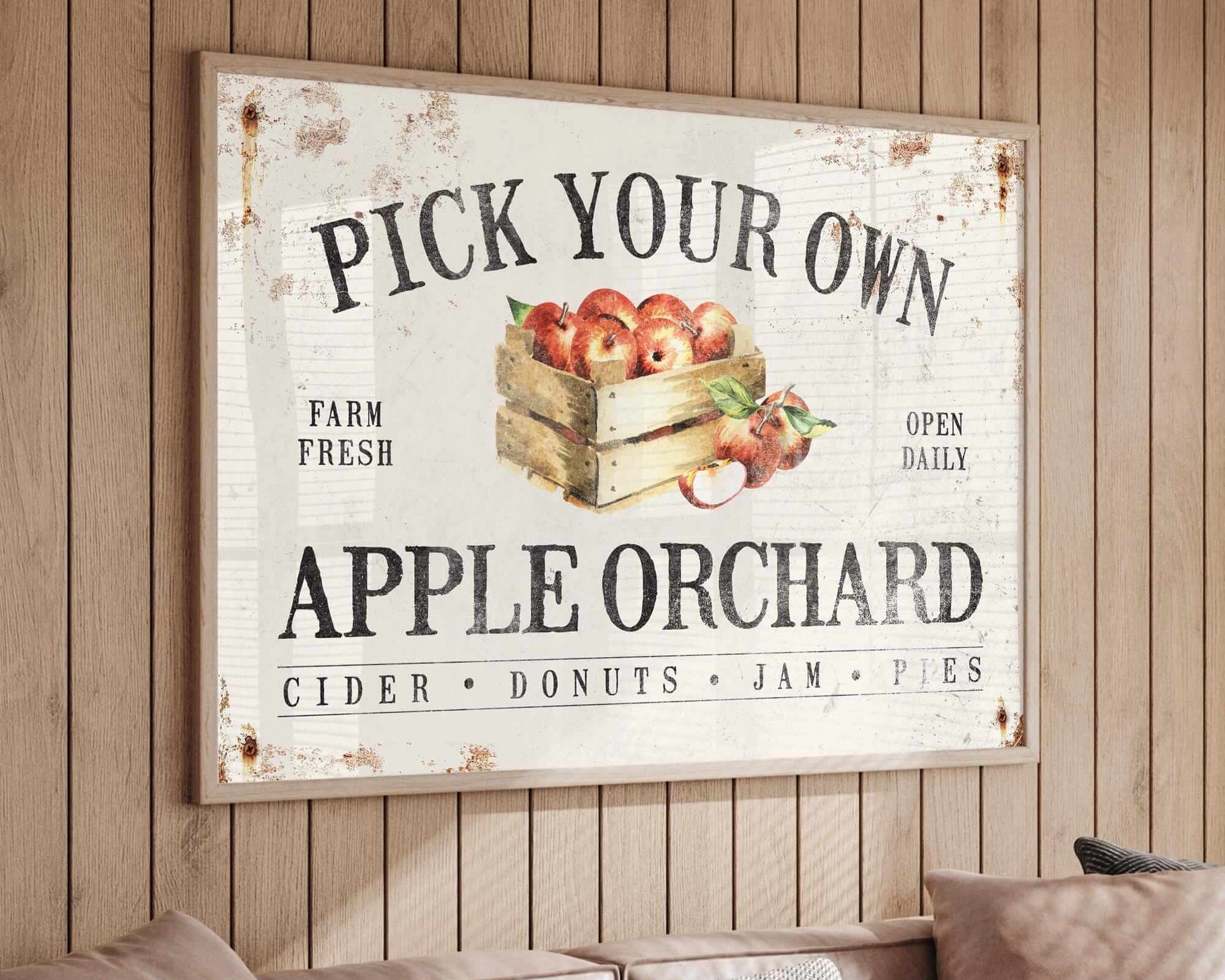 a picture of an apple orchard sign hanging on a wall