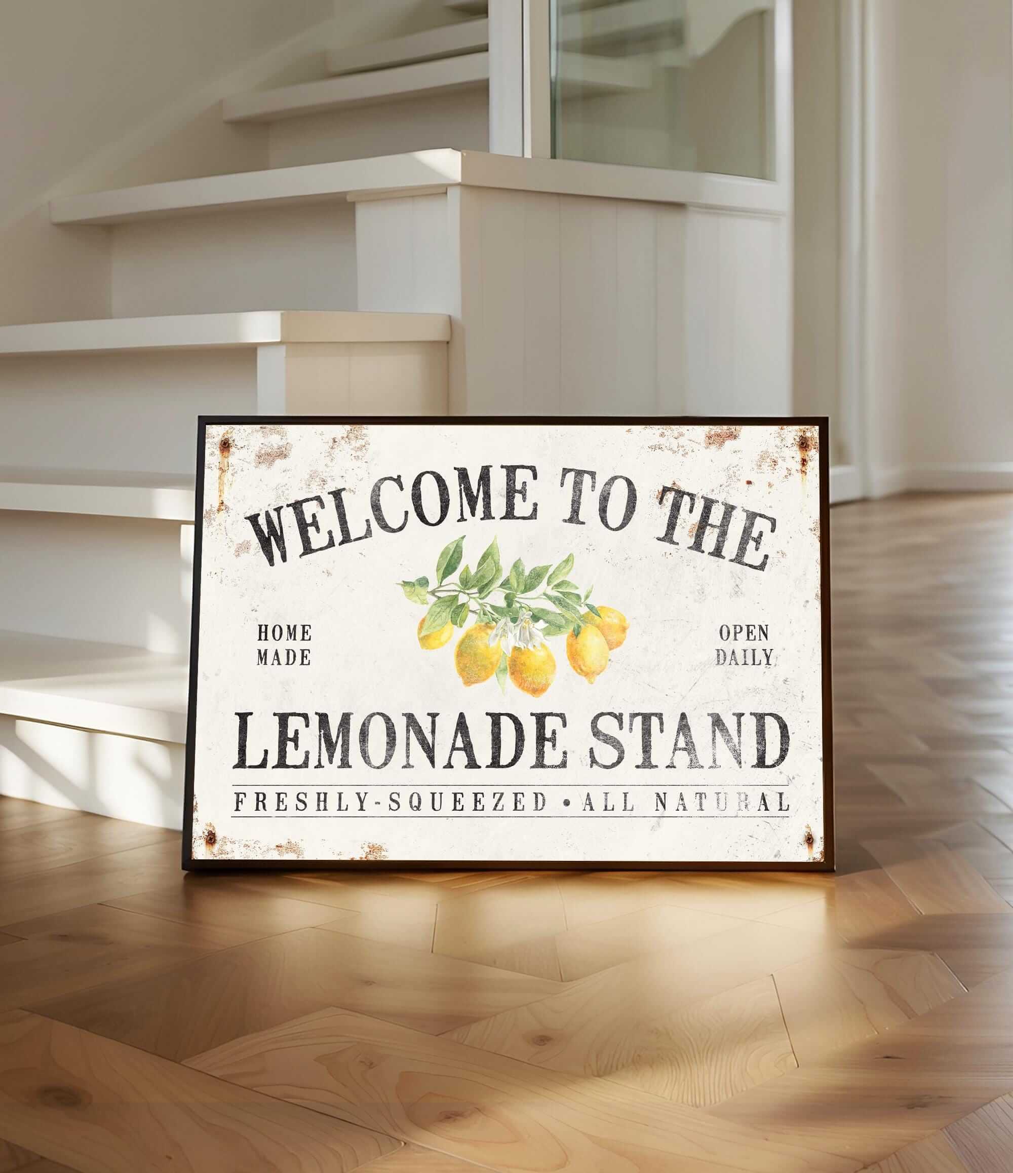 a welcome to the lemonade stand sign on a wooden floor