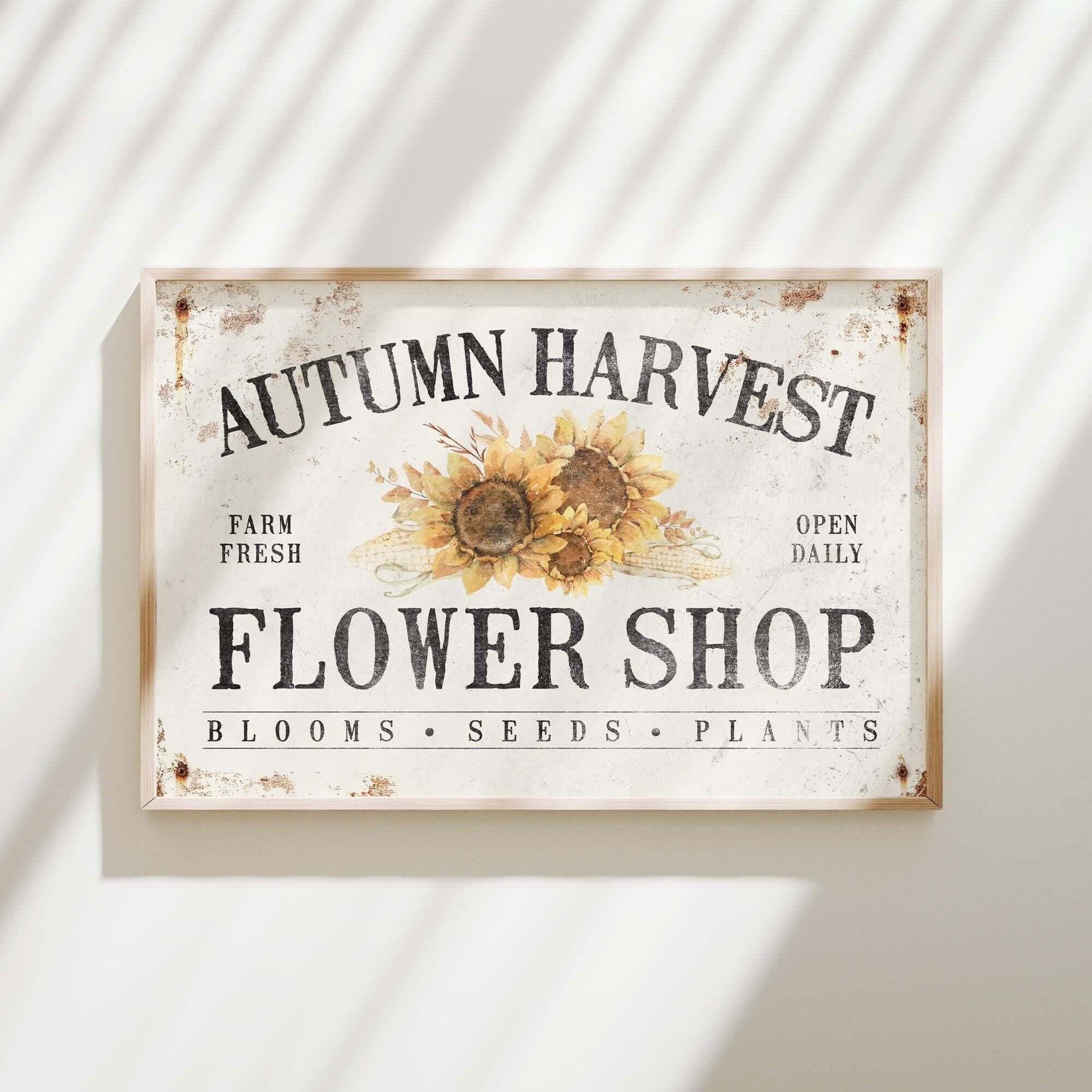 a sign on a wall that says autumn harvest flower shop