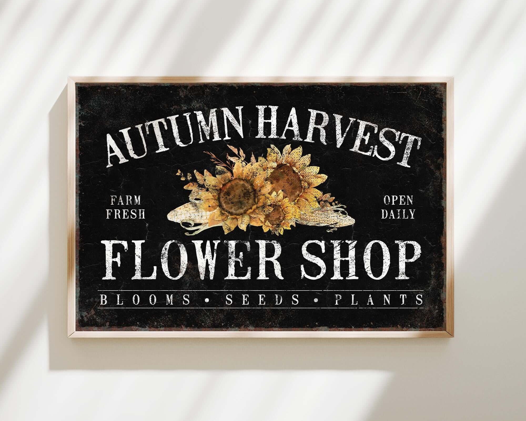a sign on a wall that says autumn harvest flower shop