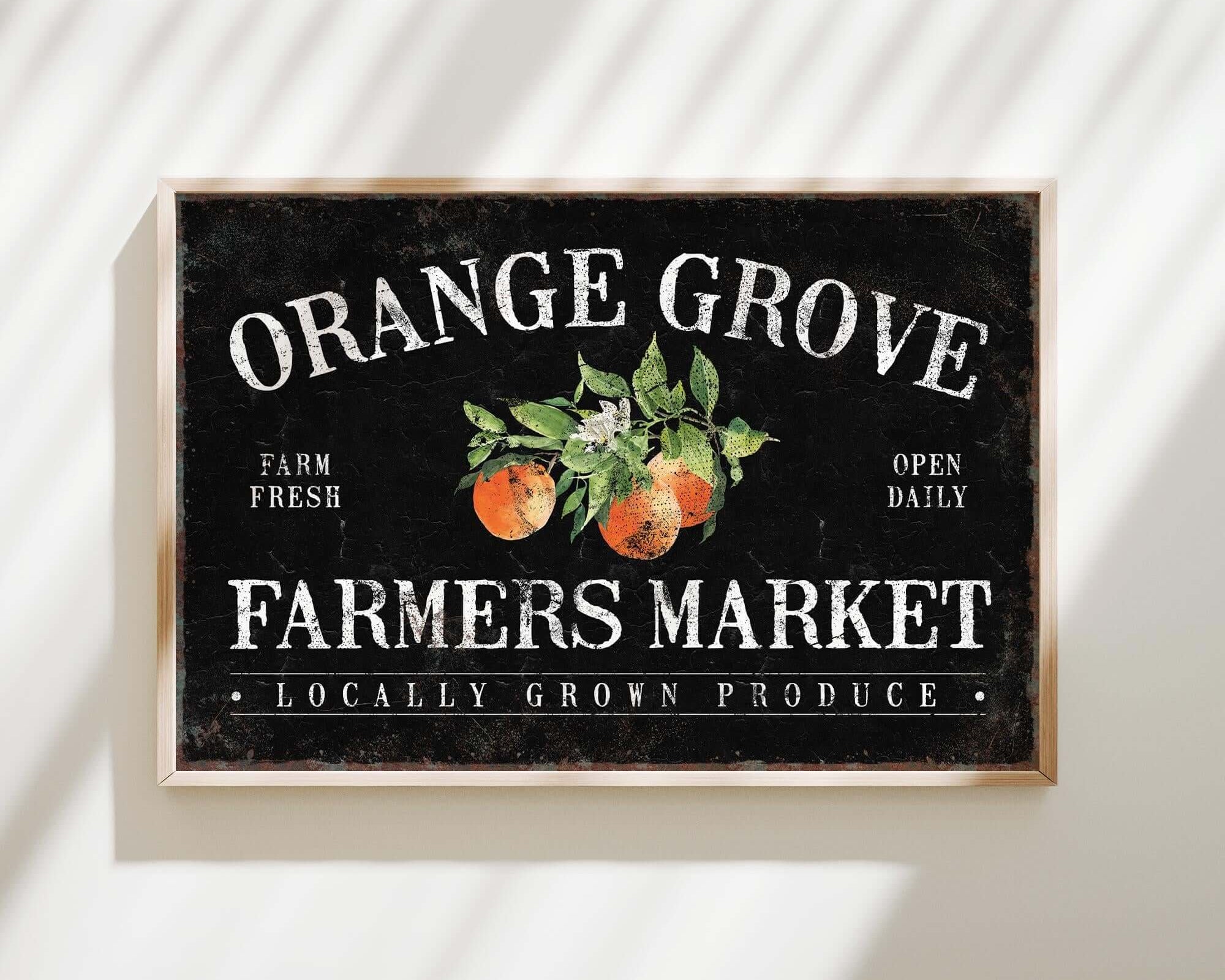 an orange grove farmers market sign hangs on a wall