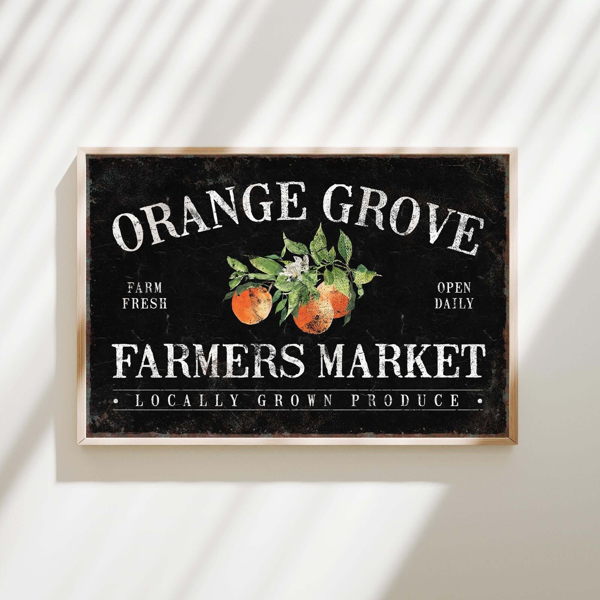an orange grove farmers market sign hangs on a wall