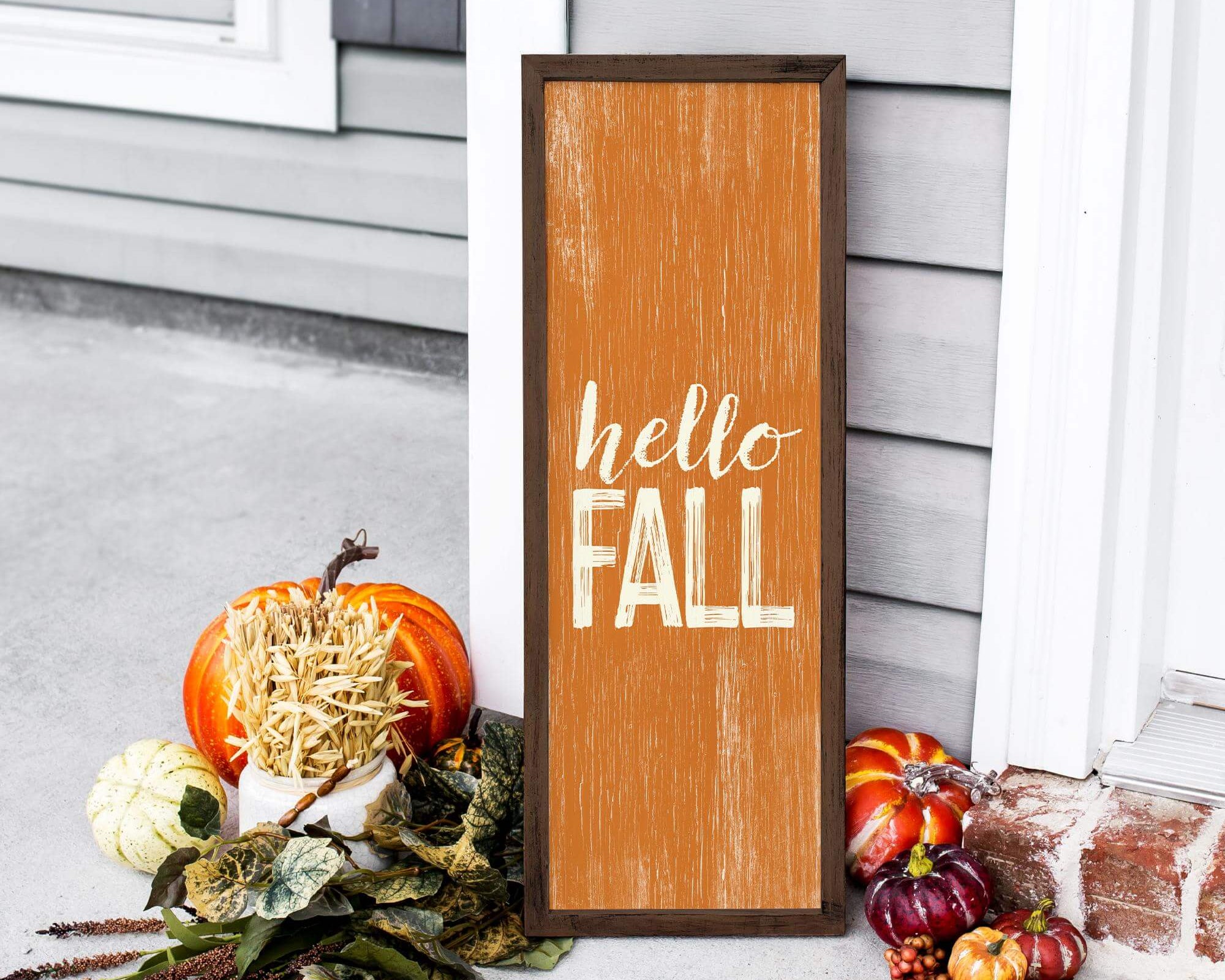 a wooden sign that says hello fall next to pumpkins and gourds