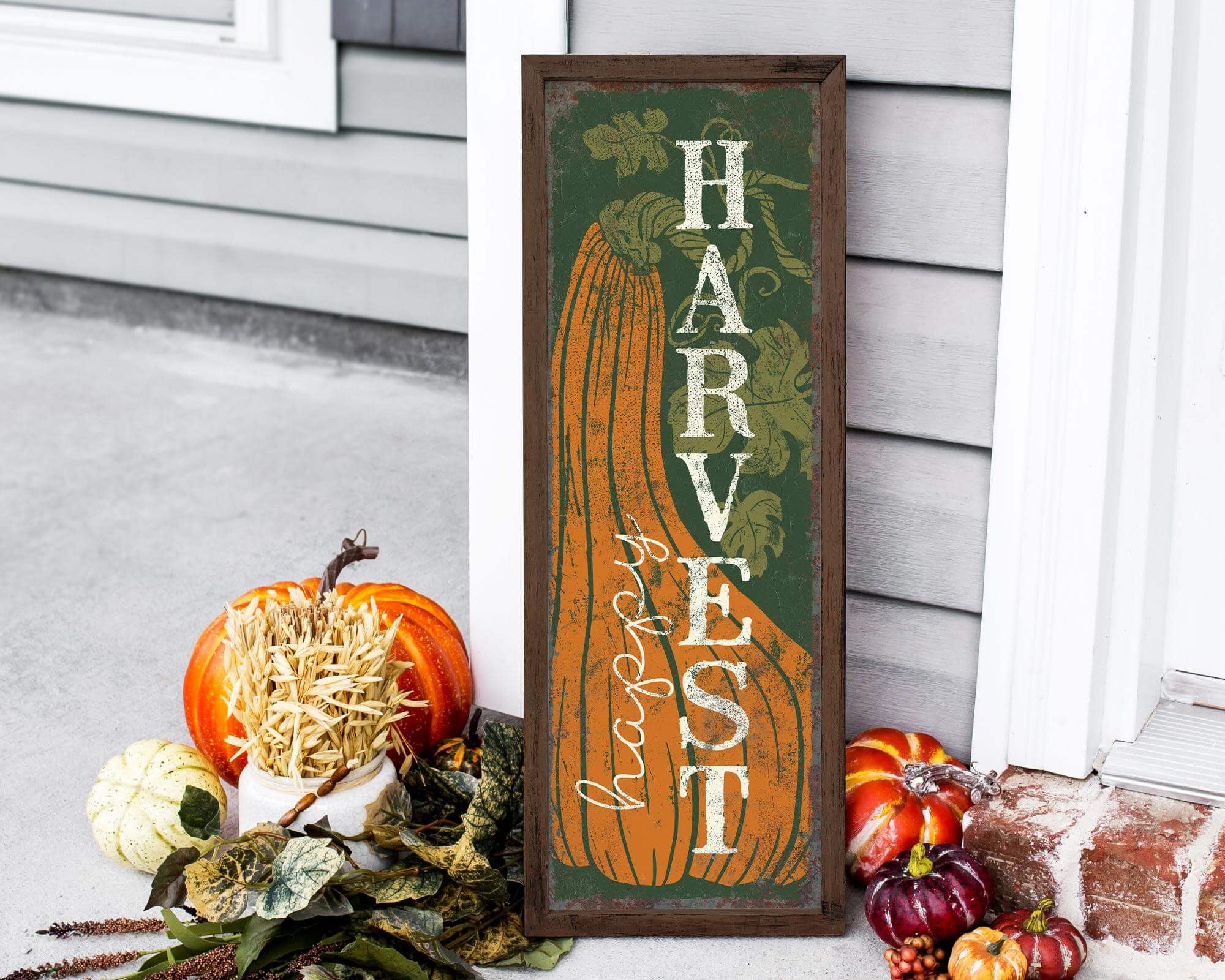 a sign sitting on the side of a house next to pumpkins