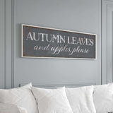 a living room with a white couch and a sign that says autumn leaves and apples