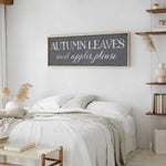 a bedroom with a white bed and a wooden sign above it