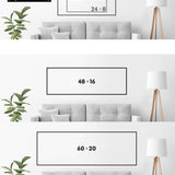 a white couch sitting next to a lamp on top of a table