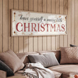 a living room with a christmas sign on the wall