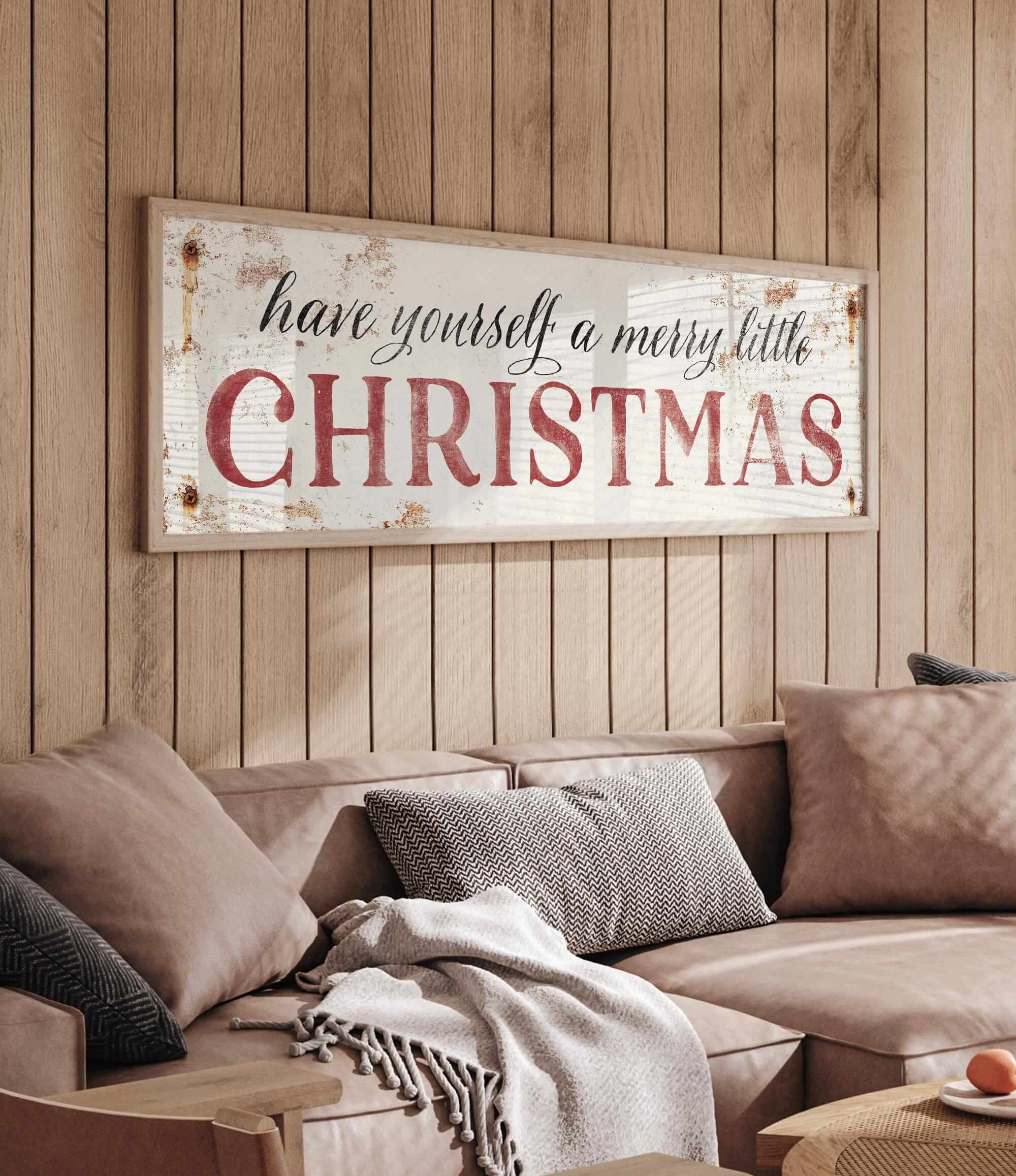 a living room with a christmas sign on the wall