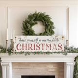 a mantel with a wreath and a sign that says have yourself a merry little