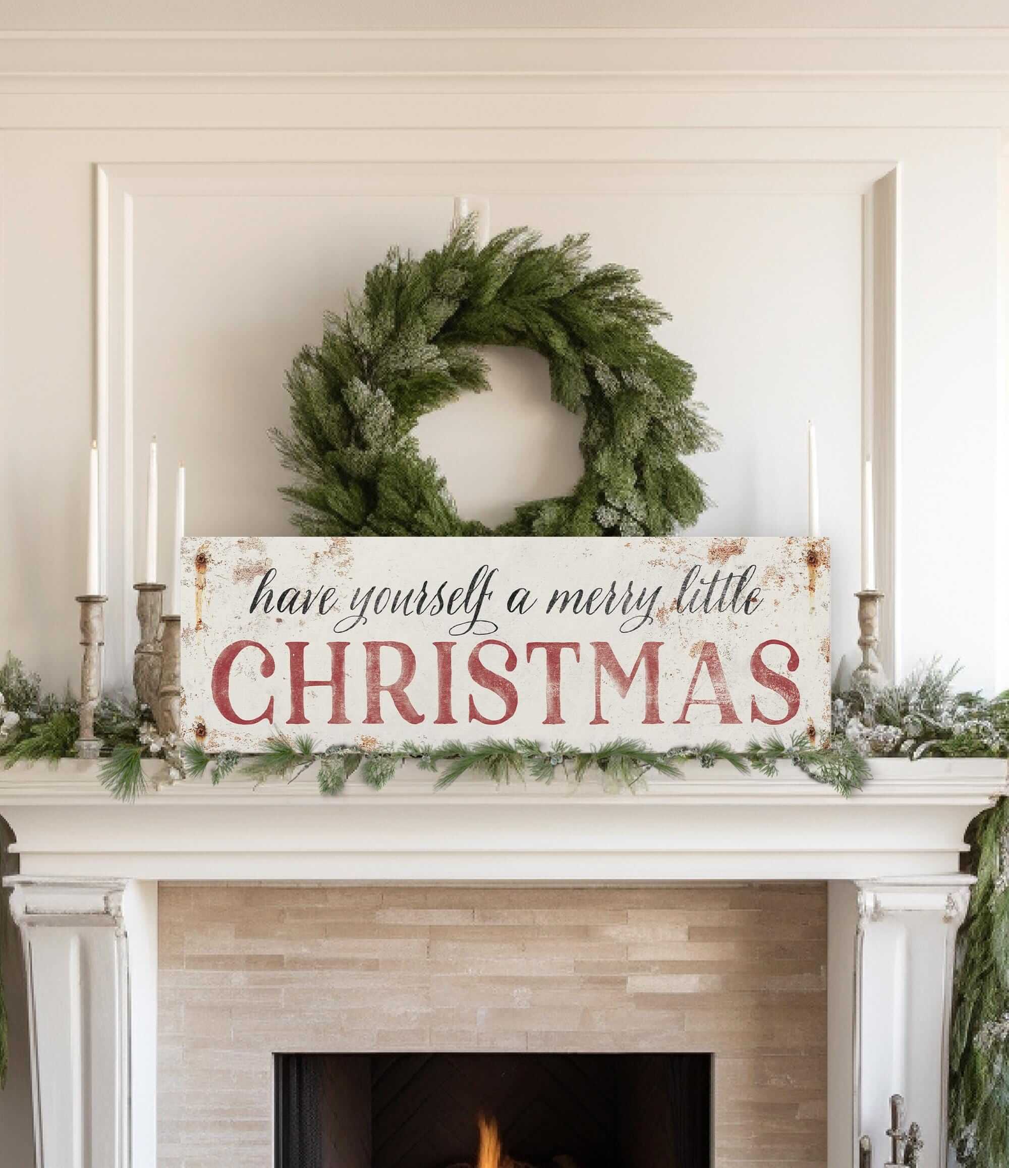 a mantel with a wreath and a sign that says have yourself a merry little